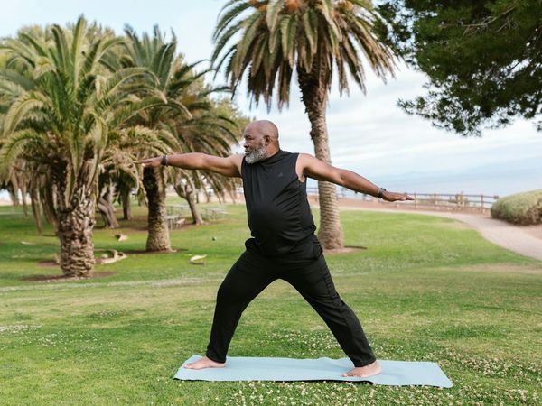 Person meditating peacefully in a calm, natural setting.